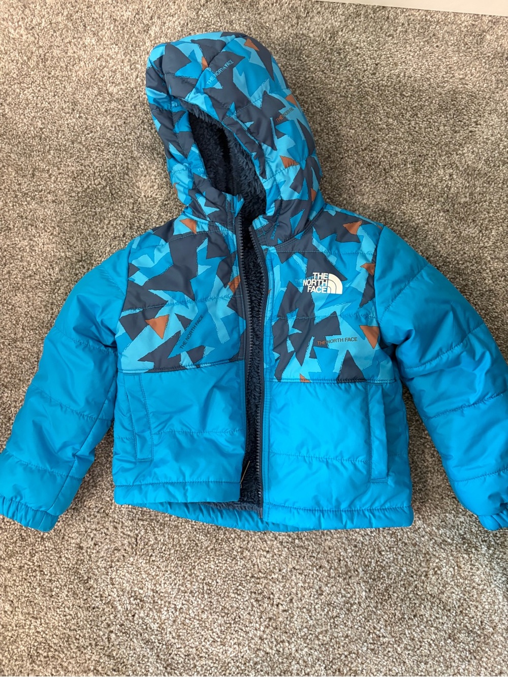 The North Face Toddler Teal and Navy Hooded Puffer Jacket. Reversible